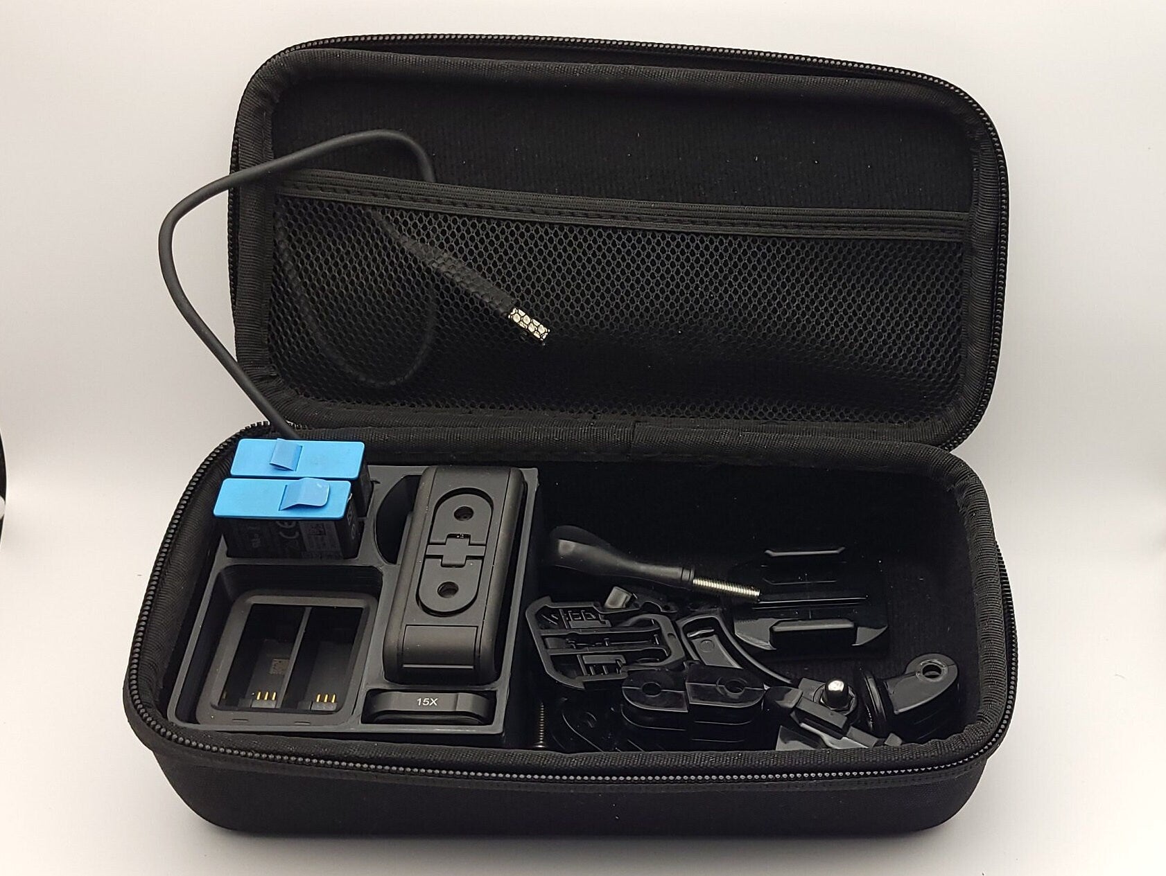 Black GoPro Case Organizer displayed in hard shell case with camera and accessories | Charge Batteries on the Go | Sturdy Protection | AirTag Slot | SHORT Version | PLA or Heat Resistant PETG
