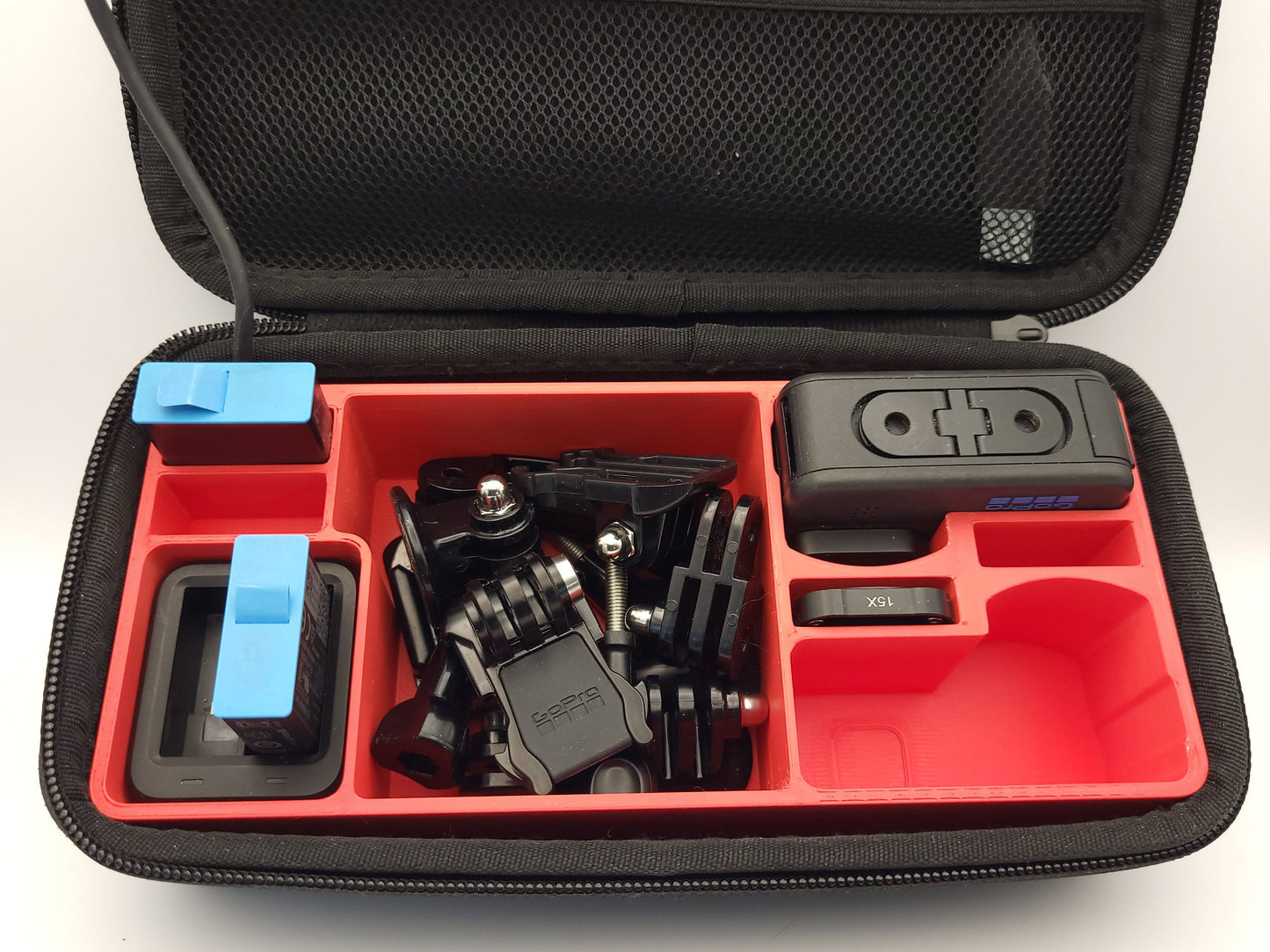 Red GoPro Case Organizer for Two Cameras displayed in hard shell case with camera and accessories | Charge Batteries on the Go | Sturdy Protection | AirTag Slot | PLA or Heat Resistant PETG